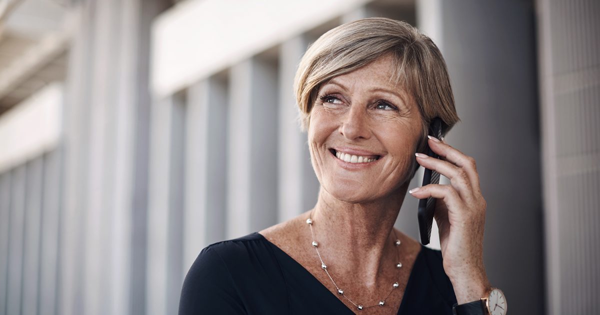 Mature woman, business and phone call in city for conversation, legal consulting or advice. Contact, speaking and female lawyer with mobile for discussion, negotiation or confirm meeting at court