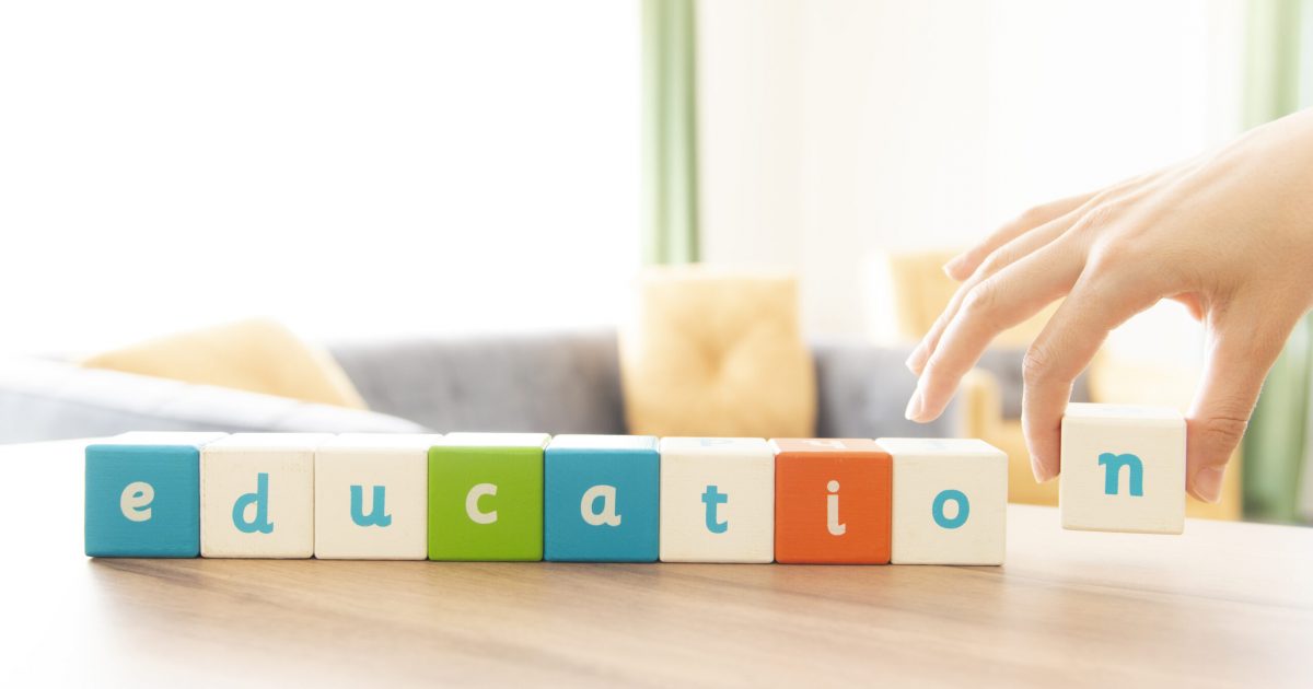 Education, word and human hand holding toy block