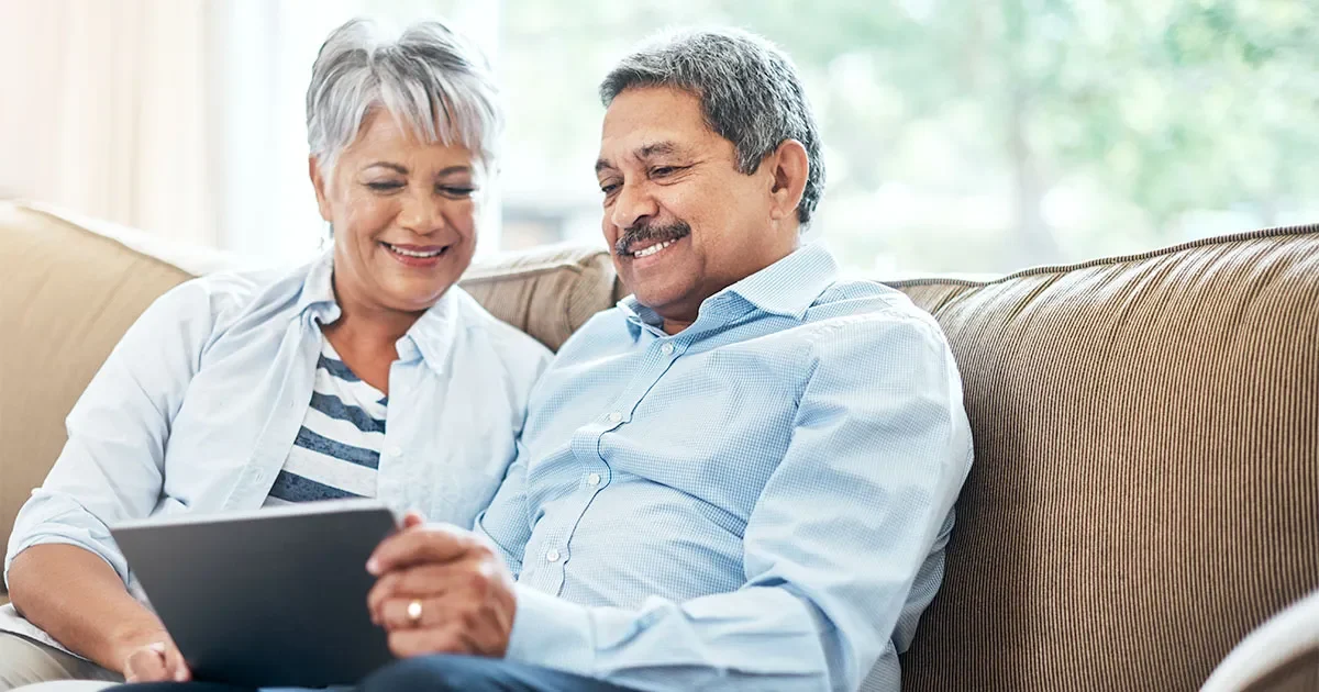 Senior couple using a tablet together at home